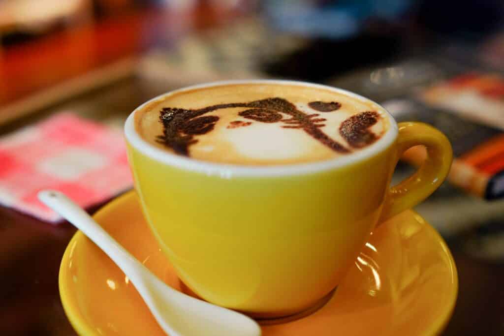 cat caffe art in yellow cup